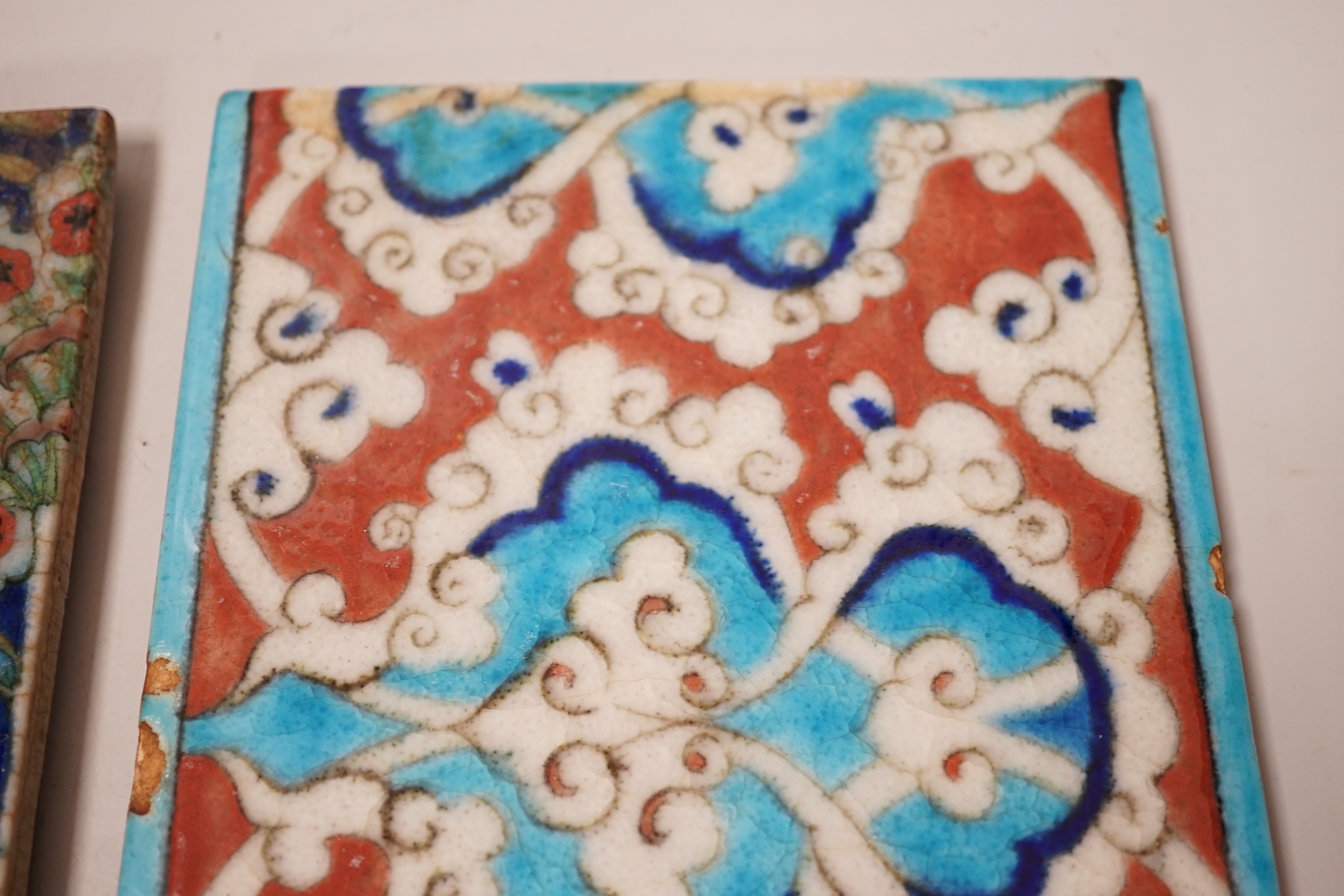 Two small Turkish Iznik pottery tiles, decorated with stylised flowers, each 24cm x 16cm